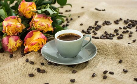 Fresh italian style coffee next to flower bouquetの写真素材