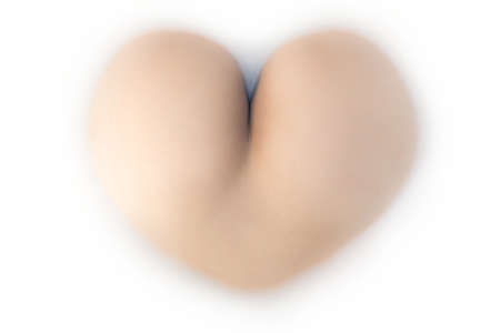 Girl with a butt in a shape of heart is laying in milk