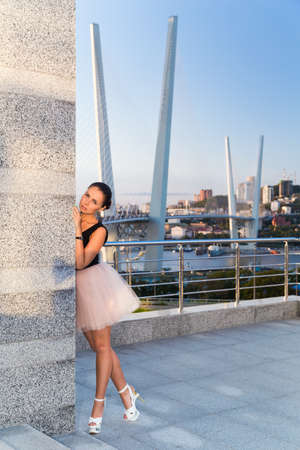 Girl in Ballet dancer dress is standing outside in sunset lightの写真素材