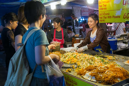 CHIANG MAI, THAILAND - CIRCA AUGUST 2015: Local people sell traditional Thai food and drinks at night market in Chiang Mai, Thailandのeditorial素材