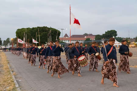 YOGYAKARTA, INDONESIA - CIRCA SEPTEMBER 2015: Ceremonial Sultan Guards in sarongs march in formation in front of Sultan Palace (Keraton), Yogyakarta, Indonesiaのeditorial素材