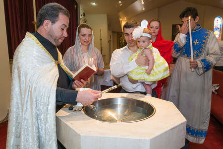 HOUSTON, TX/USA - 04 04 2015: Christian Baptising a girl in St. Kevork Armenian Church in Houston,...