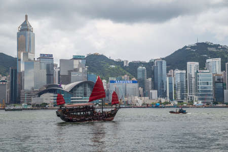 Hong Kong, SAR China - circa July 2015: Chinese junk boat sails in Victoria Harbour, Hong Kongのeditorial素材