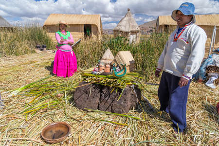 Puno, Peru - circa June 2015: Family at Uros floating island and village on Lake Titicaca near Puno, Peruのeditorial素材