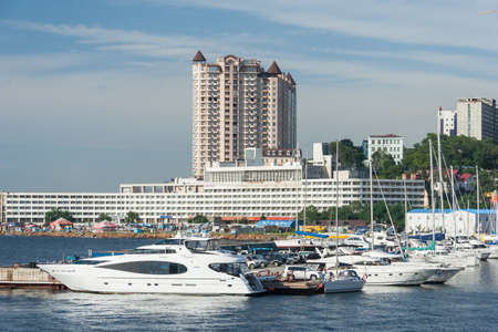 Vladivostok, Russia - circa August 2014: Sailing boats and high rise residential buildings in Vladivostok, Russiaのeditorial素材