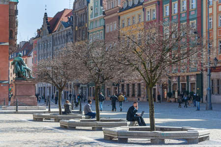 Wroclaw, Poland - circa March 2012: People sitting and relaxing at central Market square in Wroclaw, Polandのeditorial素材