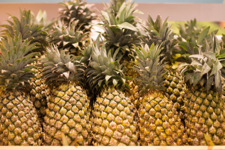 Pineapples on a shelf in a fruit store, Thailand.の写真素材