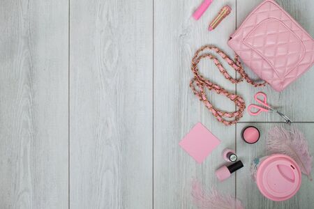 Pink flatlay on white wood background. Flat layout. Beauty and fashionの写真素材
