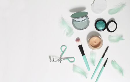 Fashion cosmetic set. Flat layout with feathers and mint make up brushesの写真素材