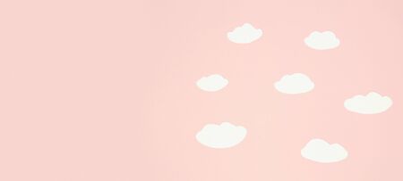 Cute paper clouds on pastel paper backgroundの写真素材