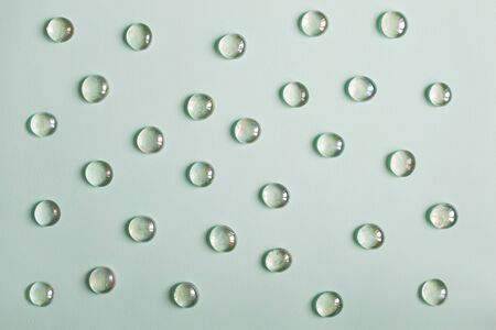 Glass imitating water drops on green backgroundの写真素材