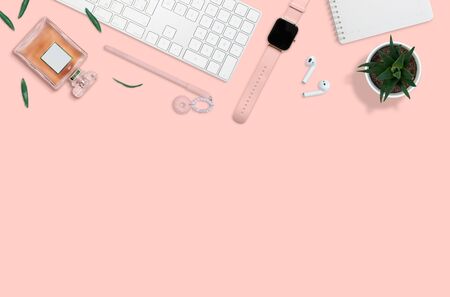 Flat layout of women workplace. Succulent, perfume and accessories on pink backgroundの写真素材