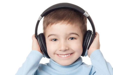 Smiling boy in headphones over white backgroundの写真素材