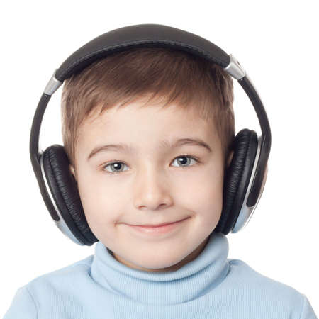 Smiling boy in headphones over white backgroundの写真素材