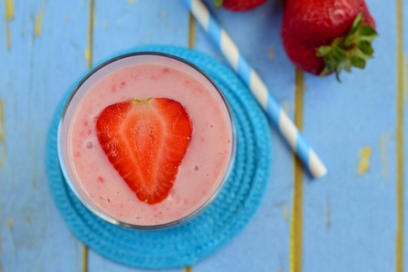 Strawberry smoothie on blue backgroundの写真素材