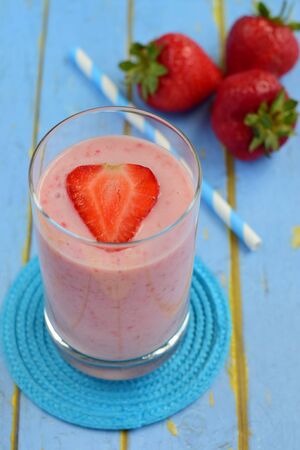 Strawberry smoothie on blue backgroundの写真素材