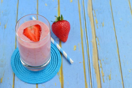Strawberry smoothie on blue backgroundの写真素材