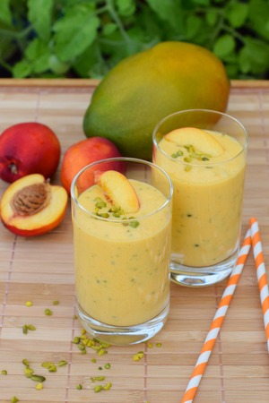Nectarine mango smoothie with pistachioの写真素材