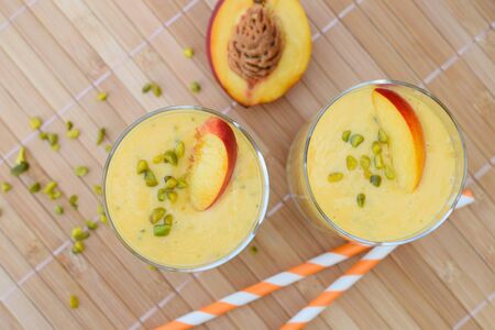 Nectarine mango smoothie with pistachioの写真素材