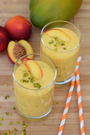 Nectarine mango smoothie with pistachioの写真素材
