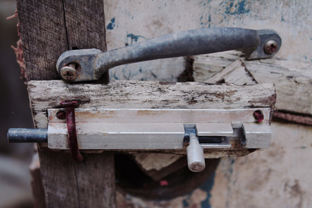 Old  latch with rust on the wood door