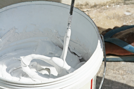 Using equipment made from steel mixed powders plaster gypsum and water in  bucketの写真素材