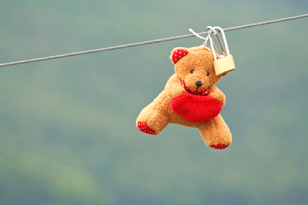 Lovers locks and  doll hanging on the new bridgeの写真素材