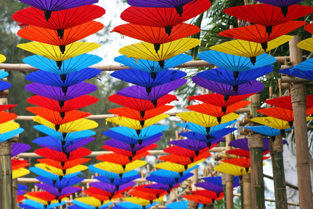 Colorful umbrellas hanging on bamboo wood at Chiang Mai Flower Festival.の写真素材