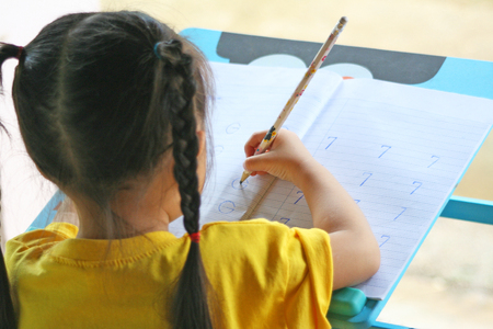 Asian children three years old doing homework with intent.の写真素材