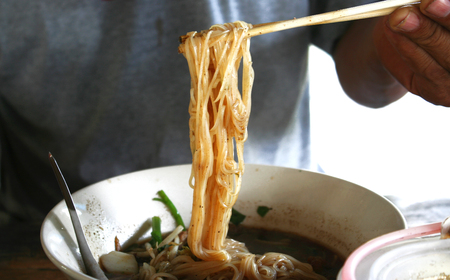 Man holding chopstick with
