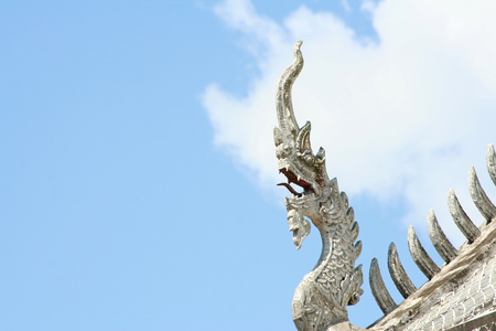 Traditional  Silver naga head sculpture on clear sky backgroundの写真素材