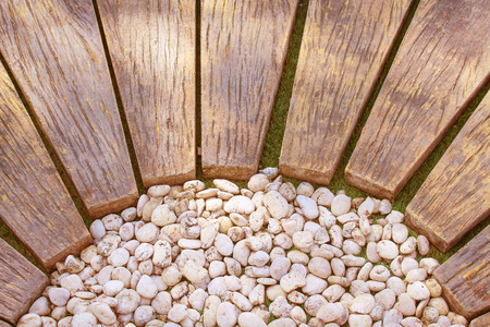 Brown wood walkway with white small rocks pattern in the garden,Natural backgroundの写真素材