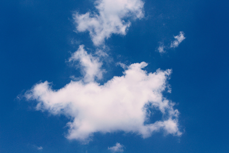 Clouds shape patterns with reflection on clear blue sky background in summer dayの写真素材