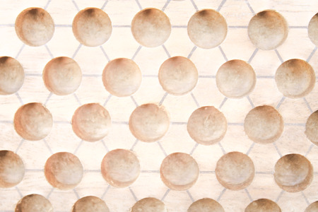 Light brown wood background with potholes design abstract texture