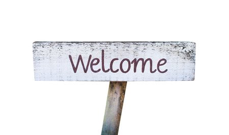Old rustic white wood welcome sign with text brown paint isolated on white backgroundの写真素材