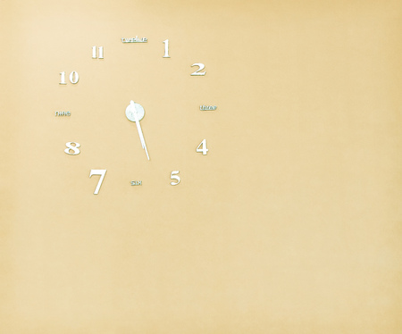 Single old clock patterns on light brown concrete wall background with copy space
