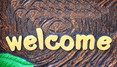 Gold paint alphabet welcome sign patterns abstract on backgroundの写真素材