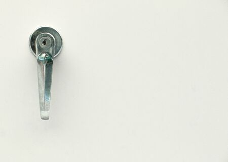 Safe door and old steel handle with hole key on metal background , copy space