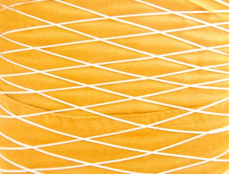 Gold fabric background with interlace of thread patterns textureの写真素材