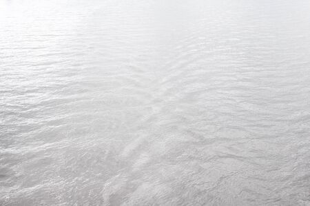 Water wave patterns in the vast river nature backgroundの写真素材