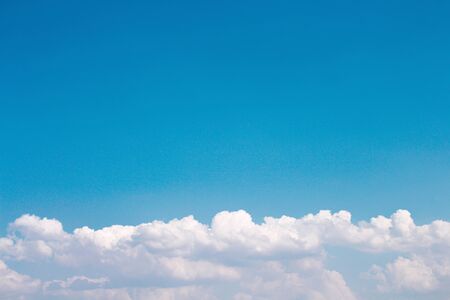 White clouds patterns on bright blue sky , summer background with copy spaceの写真素材