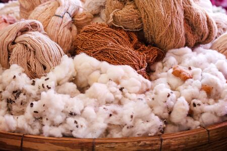Fluffy cottons and  thread in wood trayの写真素材