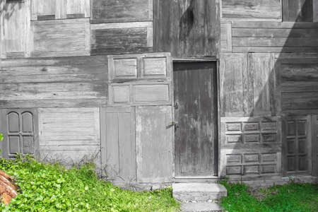 Cute goat looking in farm on plank wood wall backgroundの写真素材