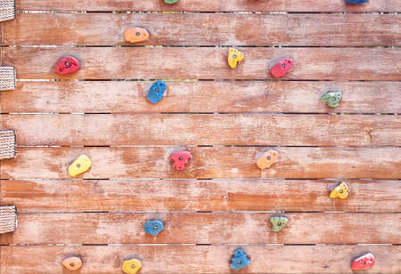 Old plank wood wall with toys rock climbing outdoor playground  , no children on backgroundの写真素材