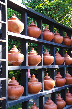 Close pottery pots for drinking water decorative on shelf in outdoor garden backgroundの写真素材