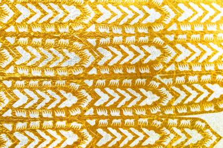 Colorful gold yellow paper sparkle with crafts cut patternson white backgroundの写真素材