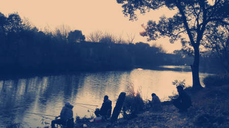 People fishing by a riverのeditorial素材