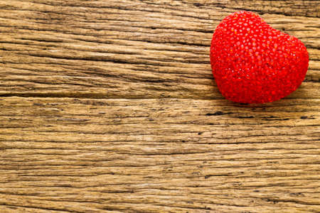 Red heart on old wooden backgroundの写真素材