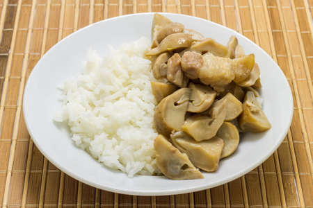 Stir fried mushrooms with pork on wooden background,Thai food.の写真素材