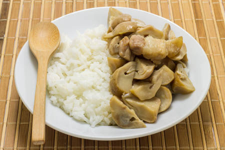 Stir fried mushrooms with pork on wooden background,Thai food.の写真素材